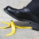A foot over a banana peel.
